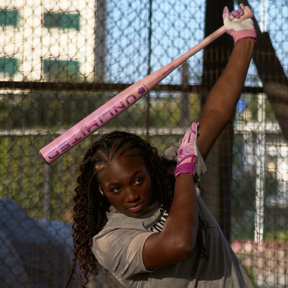2026 Easton Ghost Unlimited Fastpitch Softball Bat being swung by a softball player on a fence