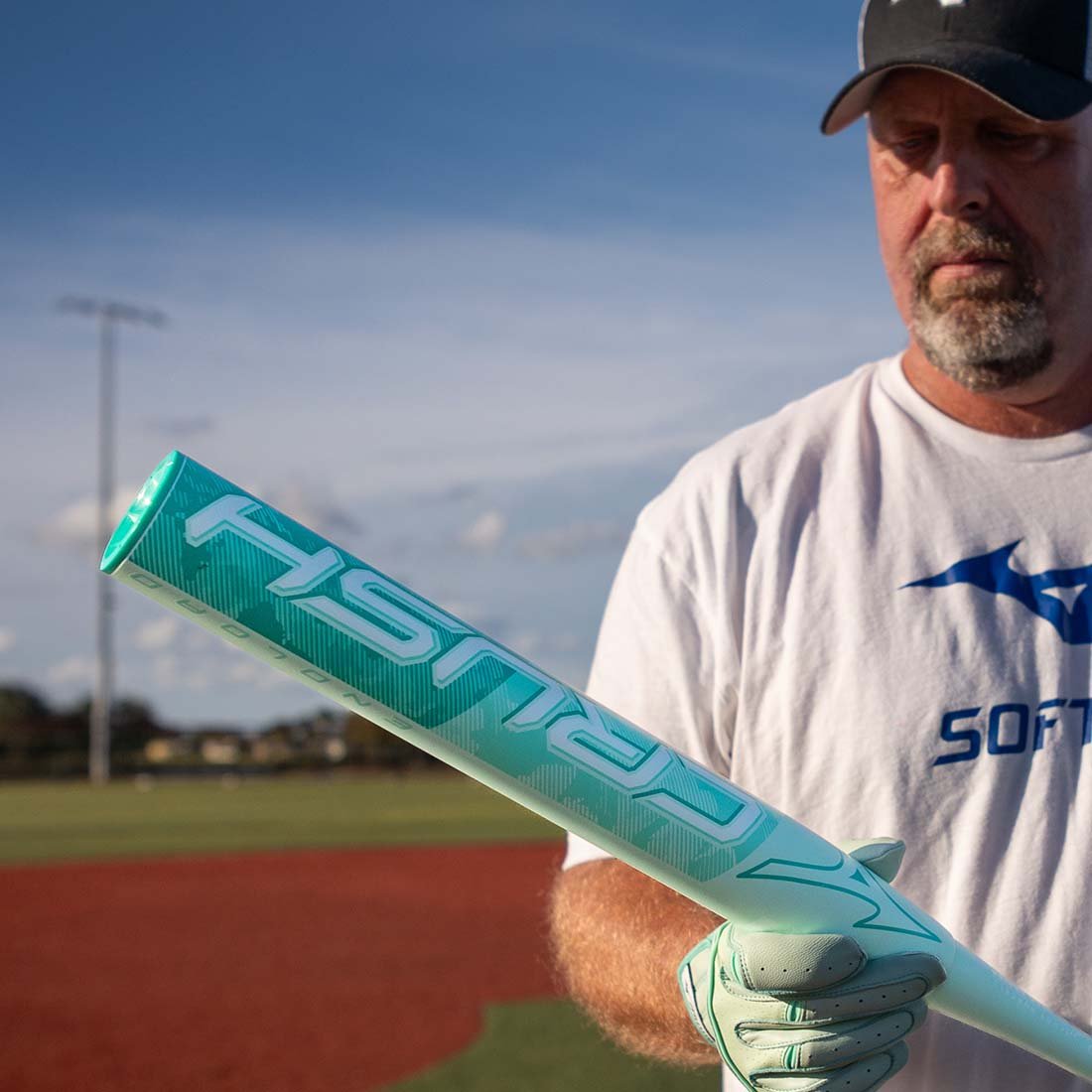 Andy Purcell Pro Softball Player holding the Mizuno Crush slowpitch softball bat from Headbanger Sports