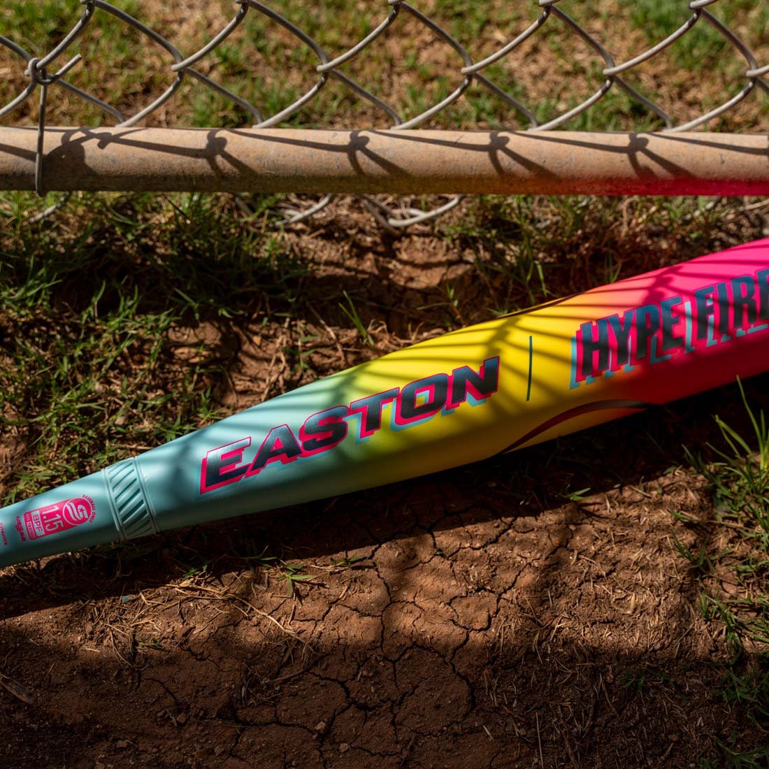 2026 Easton Hype Fire USSSA 2 3/4" Baseball Bat (EUT6HYP) laying on the ground in the dugout.