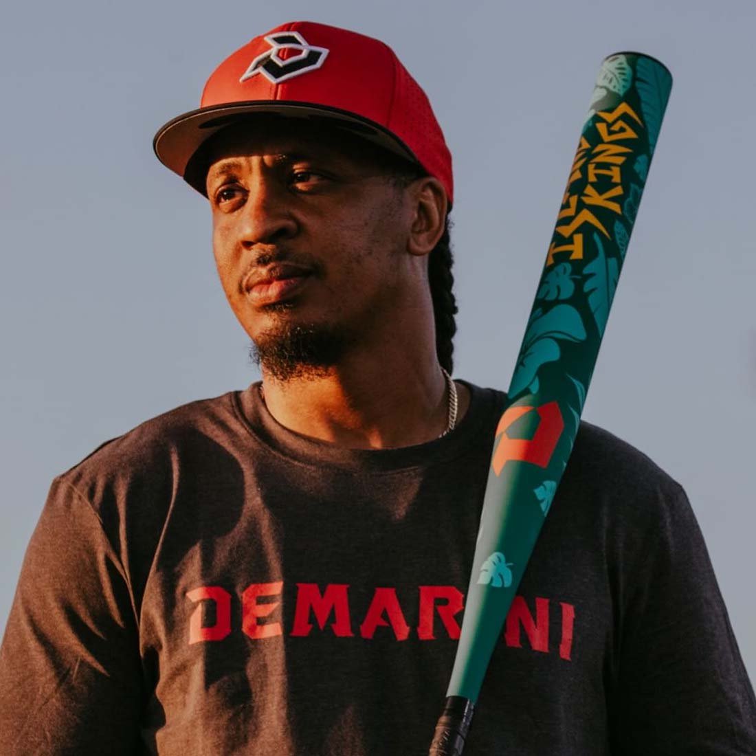 2027 DeMarini Island Kings USSSA slowpitch softball bat with 13 inch endloaded barrel held by a DeMarini Pro Player