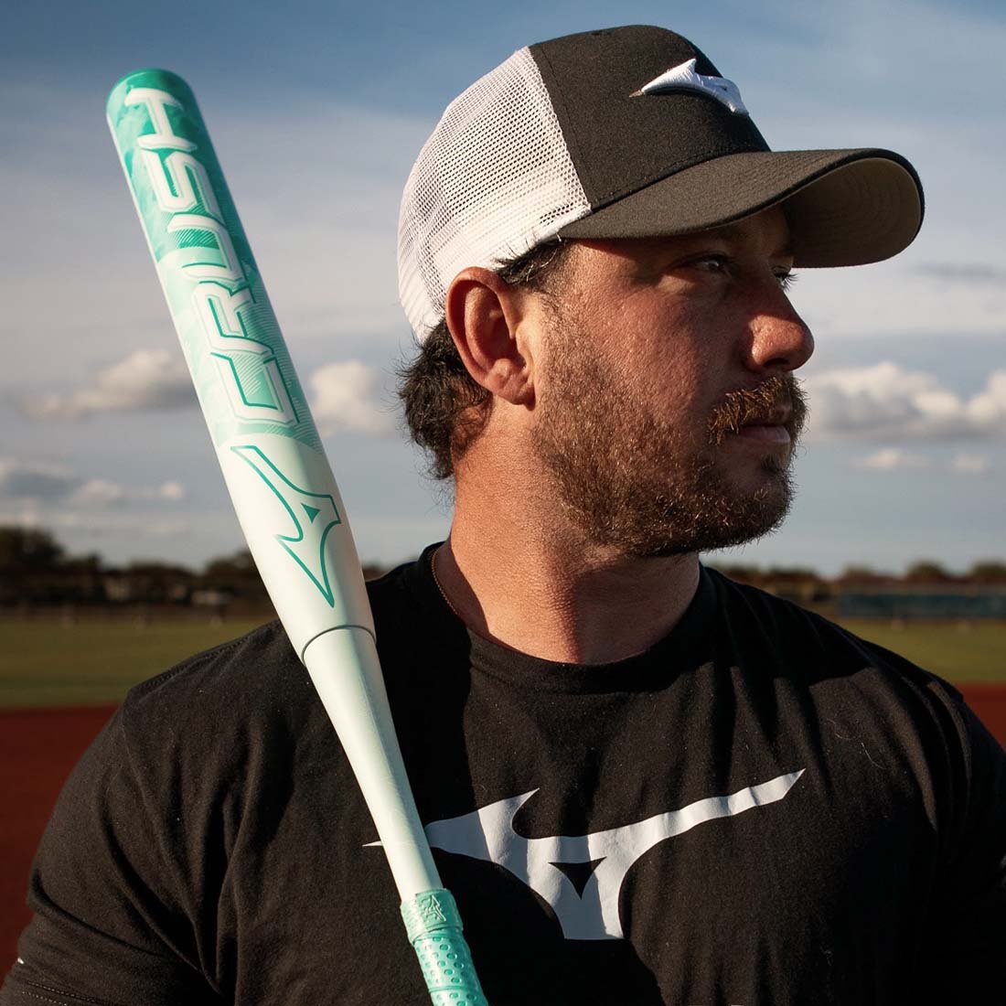 Logan Rodgers Pro Softball Player holding the Mizuno Crush slowpitch softball bat from Headbanger Sports